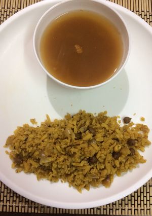 A picture of Brown Chanapoha and rasam.