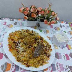 A picture of Masaledar chatpatyChicken biryani with boondi raita.