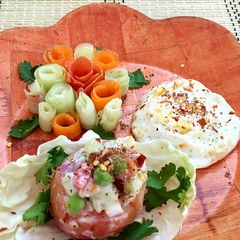 A picture of A bunch of Salad roses and a bucket of seasoning Salad with steam poached egg.