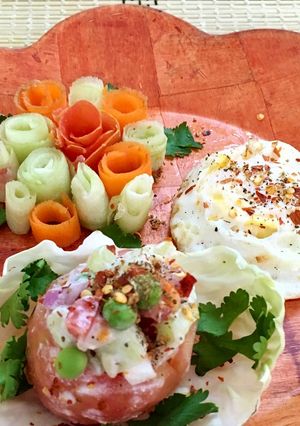 A picture of A bunch of Salad roses and a bucket of seasoning Salad with steam poached egg.