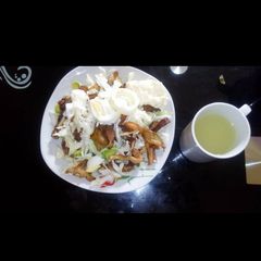 A picture of Salad with shredded chicken.