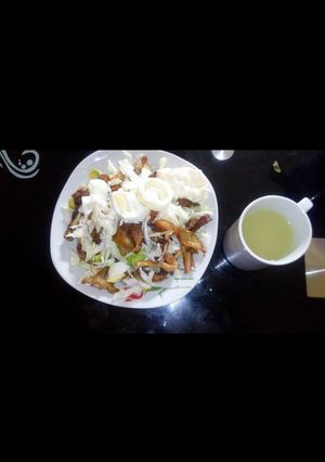 A picture of Salad with shredded chicken.
