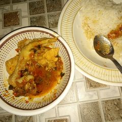 A picture of White rice and chicken pepper soup.