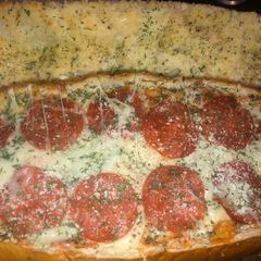 A picture of Pizza baked stuffed French bread.