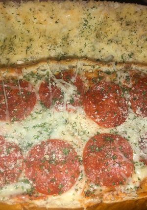 A picture of Pizza baked stuffed French bread.