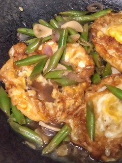 A picture of Sunny Side Up Eggs and Green Beans in Butter Sauce.