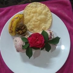 A picture of Steamed Gulkanda Rice Puttu,Chenna,Pappad &Banana.