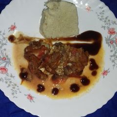 A picture of Cornbread with fish stew.