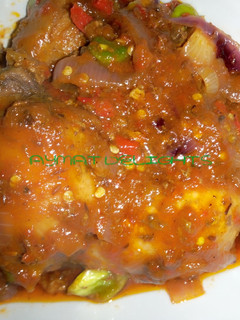 A picture of Fried chicken in ketchup sauce.