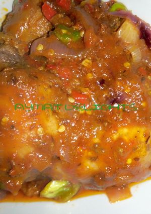 A picture of Fried chicken in ketchup sauce.