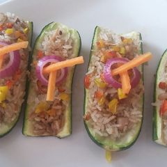 A picture of Zucchini stuffed with chicken rice.