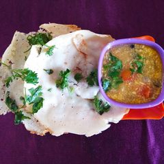 A picture of Appam with vegetable stew.