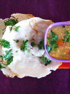 A picture of Appam with vegetable stew.