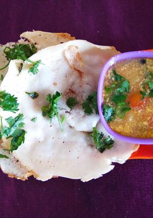 A picture of Appam with vegetable stew.