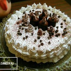 A picture of Chocolate sponge cake in pateela on stove.