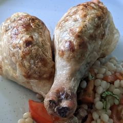 A picture of Stuffed chicken drumsticks with giant couscous salad.