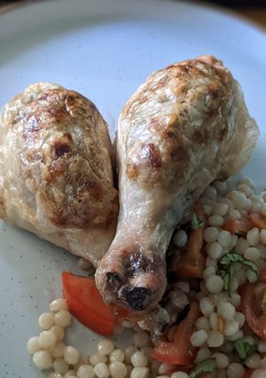 A picture of Stuffed chicken drumsticks with giant couscous salad.