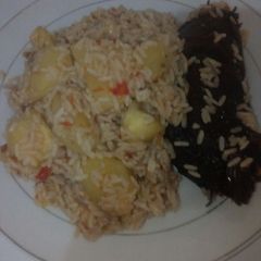 A picture of Jellof rice with sweet pototes and dried fish.