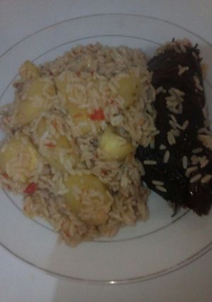 A picture of Jellof rice with sweet pototes and dried fish.