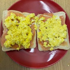 A picture of Smoked salmon and scrambled eggs on toast.