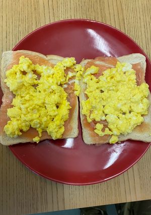 A picture of Smoked salmon and scrambled eggs on toast.