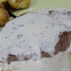 A picture of Blue cheese sirloin with roast potatoes and caramalised onions.