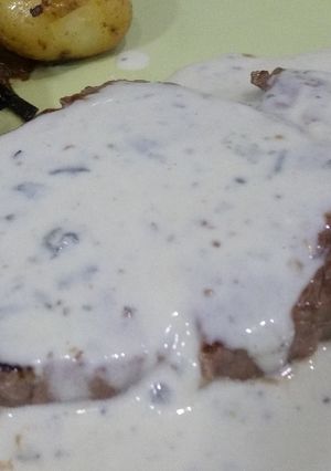 A picture of Blue cheese sirloin with roast potatoes and caramalised onions.