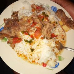 A picture of Beef stew with rice.