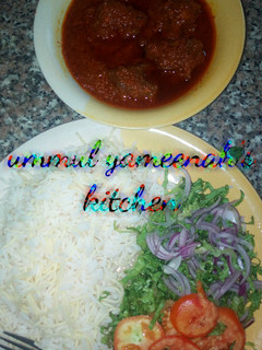 A picture of White rice and spaghetti with stew.