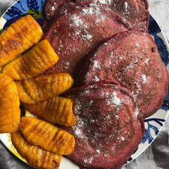 A picture of Red velvet pancakes w/ fried plantains 😃.