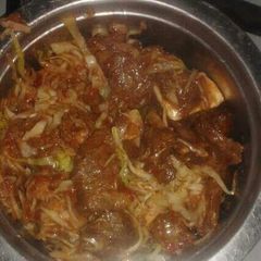 A picture of Beef stew and cabbage.
