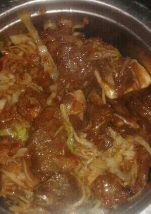 A picture of Beef stew and cabbage.