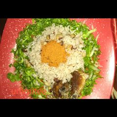 A picture of Rice and beans with salad and fried fish.