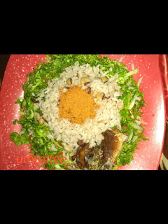 A picture of Rice and beans with salad and fried fish.