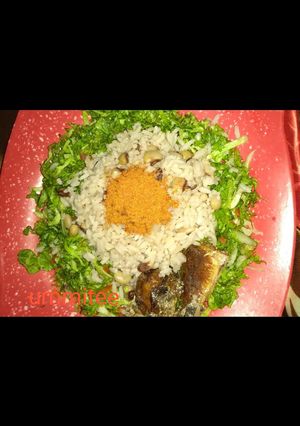 A picture of Rice and beans with salad and fried fish.
