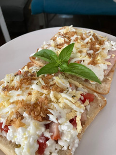Foto principal de Tostada con lomo adobado, queso cottage, tomate, huevo cocido y cebolla frita