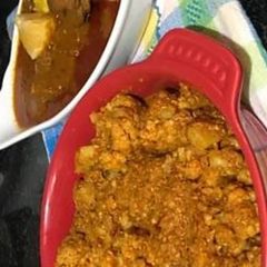 A picture of Spicy Cauliflower Roast and Fish dipped in the Orange Gravy.