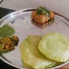 A picture of Koraishutir Kochuri (Peas Kachori) with Aloo Dum.