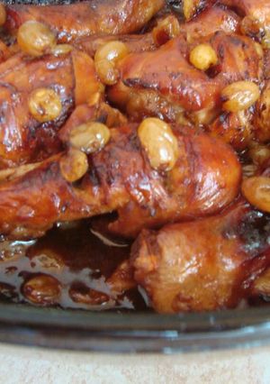 A picture of Chicken drumsticks with raisins in dark beer.