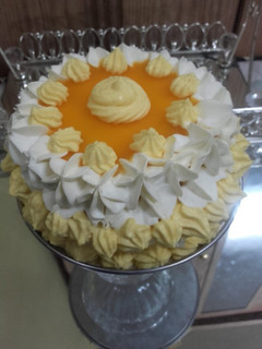 A picture of Mango Mini cake Mango whipped cream frosting.