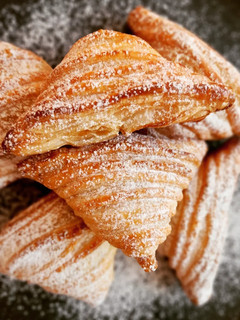 Una foto de Triángulos de hojaldre, crema y manzana