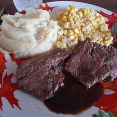A picture of Beef Roast Steaks with Garlic Mashed Potatoes and Sweet Corn.