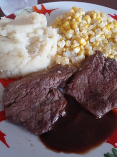 A picture of Beef Roast Steaks with Garlic Mashed Potatoes and Sweet Corn.