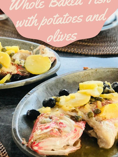 A picture of Whole Baked Fish with potatoes and olives.