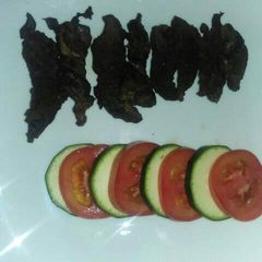 A picture of Grilled fillet strips with tomato and cucumber.