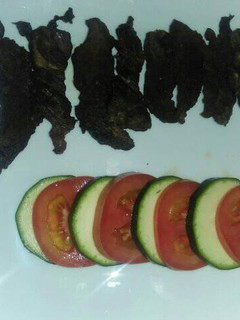 A picture of Grilled fillet strips with tomato and cucumber.