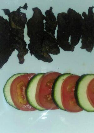 A picture of Grilled fillet strips with tomato and cucumber.