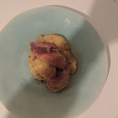 A picture of Banana pancakes with bacon and maple syrup.