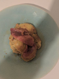 A picture of Banana pancakes with bacon and maple syrup.