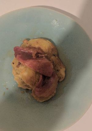 A picture of Banana pancakes with bacon and maple syrup.